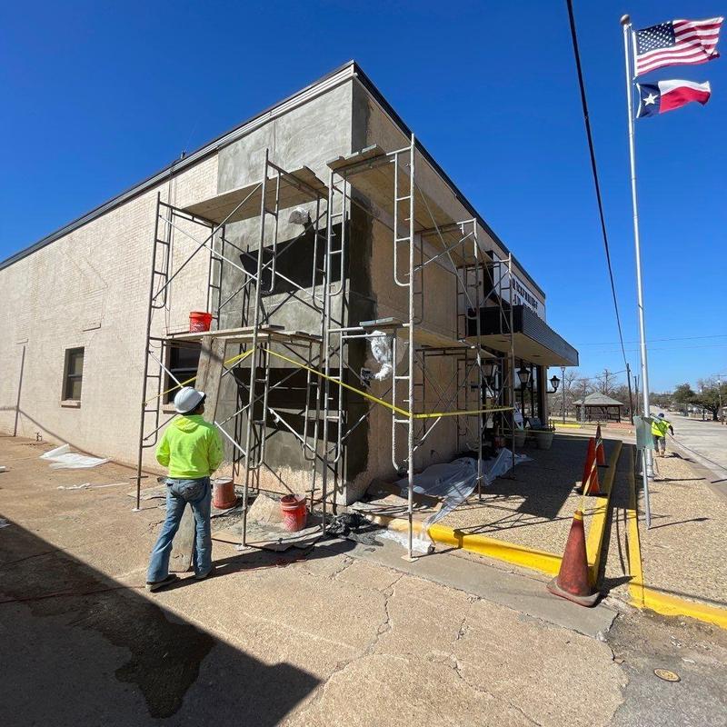 Stucco facade application on City Hall exterior walls Stucco facade application on City Hall exterior walls