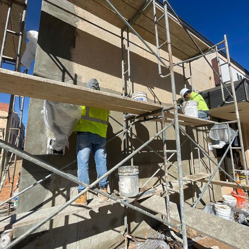 Stucco exterior wall application with scaffolding Stucco exterior wall application with scaffolding