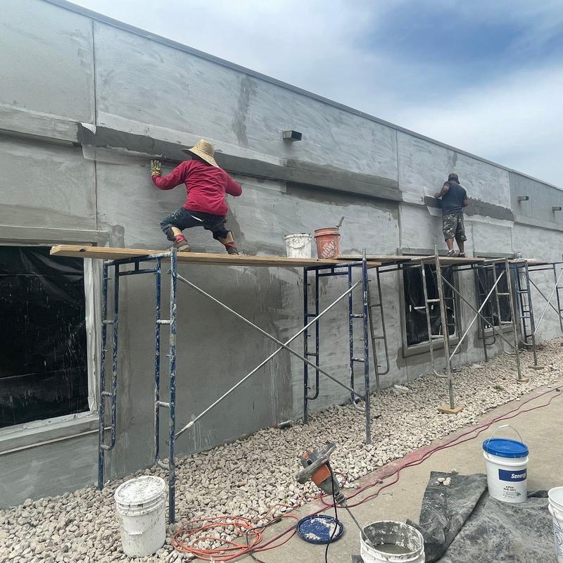 Stucco exterior facade application on commercial building Stucco exterior facade application on commercial building