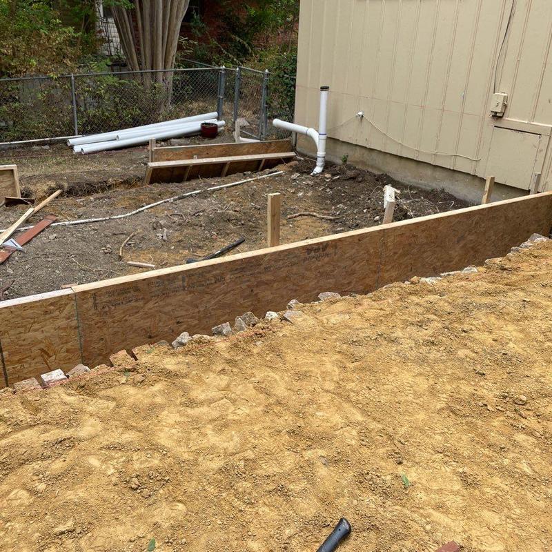 Concrete patio formwork with plumbing pipes and soil preparation Concrete patio formwork with plumbing pipes and soil preparation