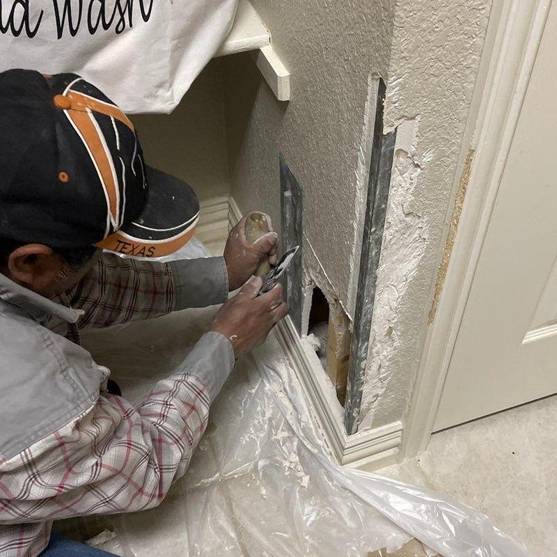 Stucco wall patching near baseboard trim Stucco wall patching near baseboard trim