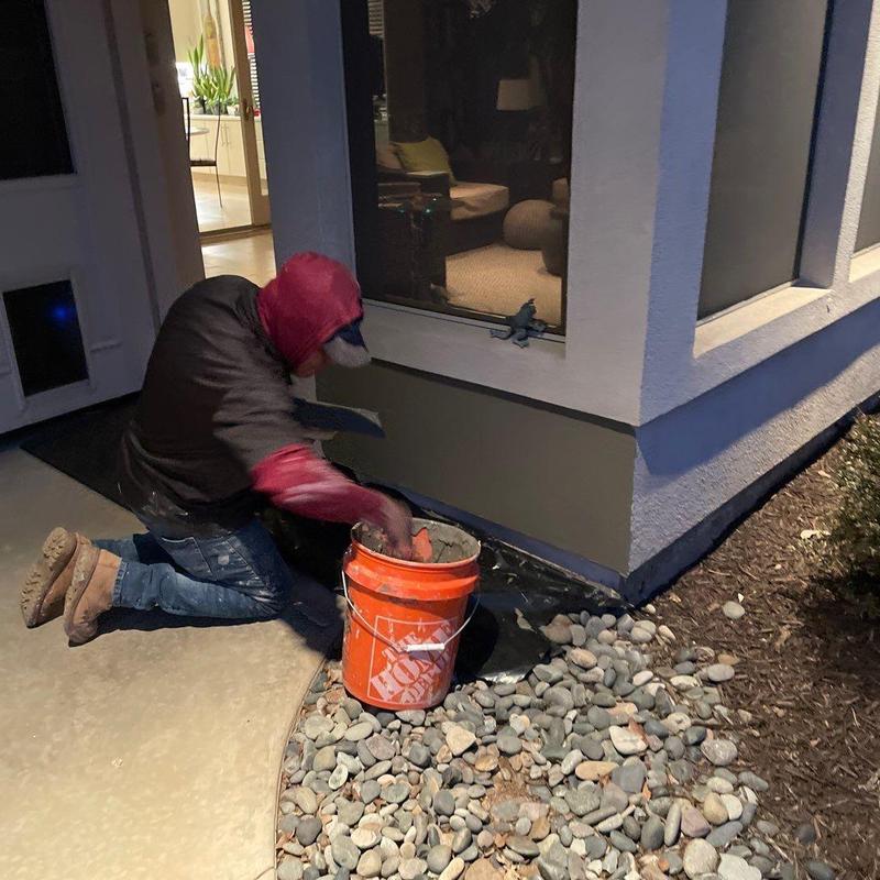 Stucco patching on home exterior corner near window Stucco patching on home exterior corner near window