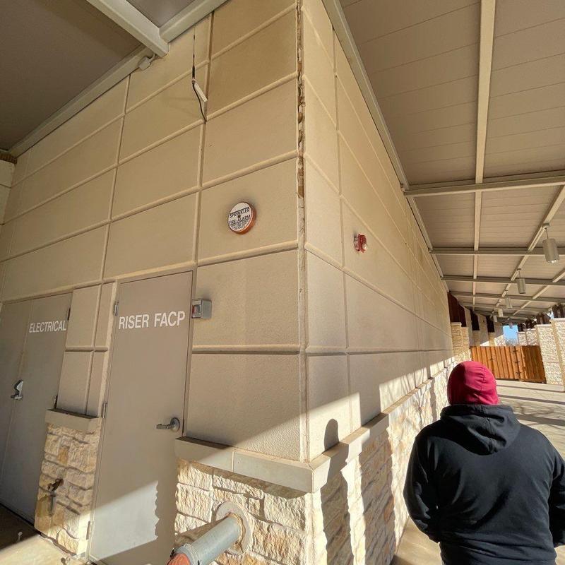 Stone and stucco exterior wall with soffit damage Stone and stucco exterior wall with soffit damage