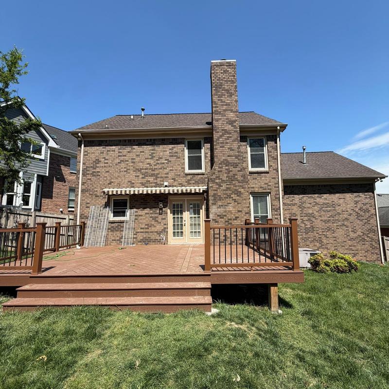 Residential brick chimney and roof with clear sky