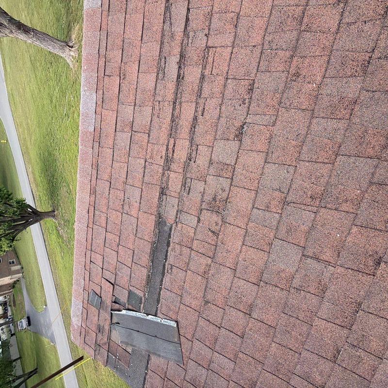 Asphalt roof shingles with hail and storm damage signs