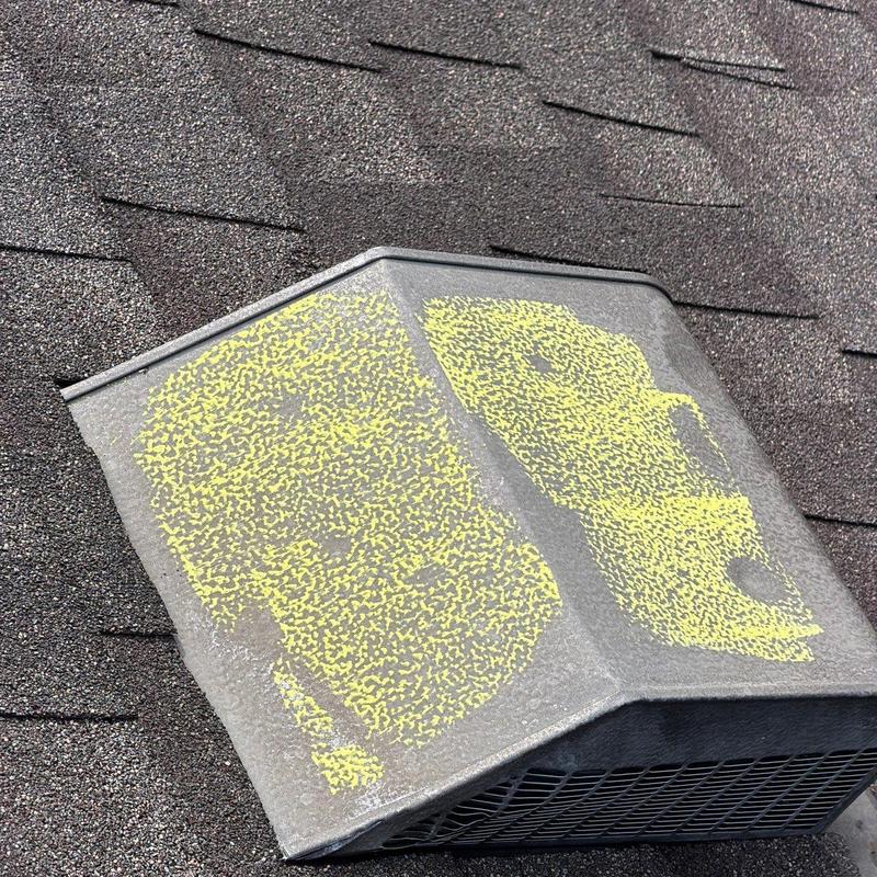 Roof vent with marked hail damage on shingles