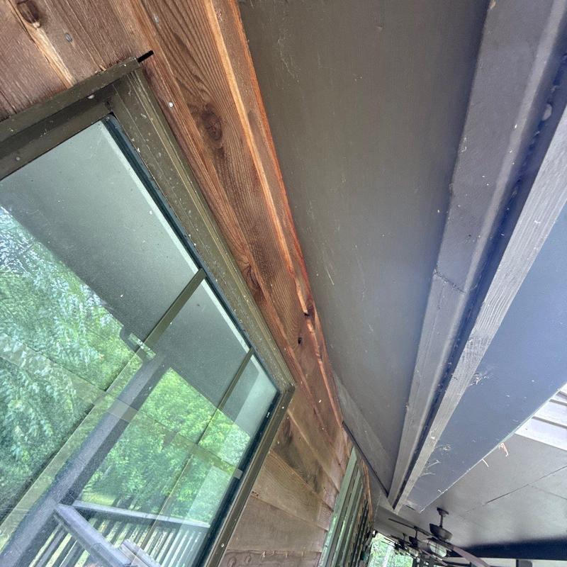 Roof eaves and fascia inspection near window frame