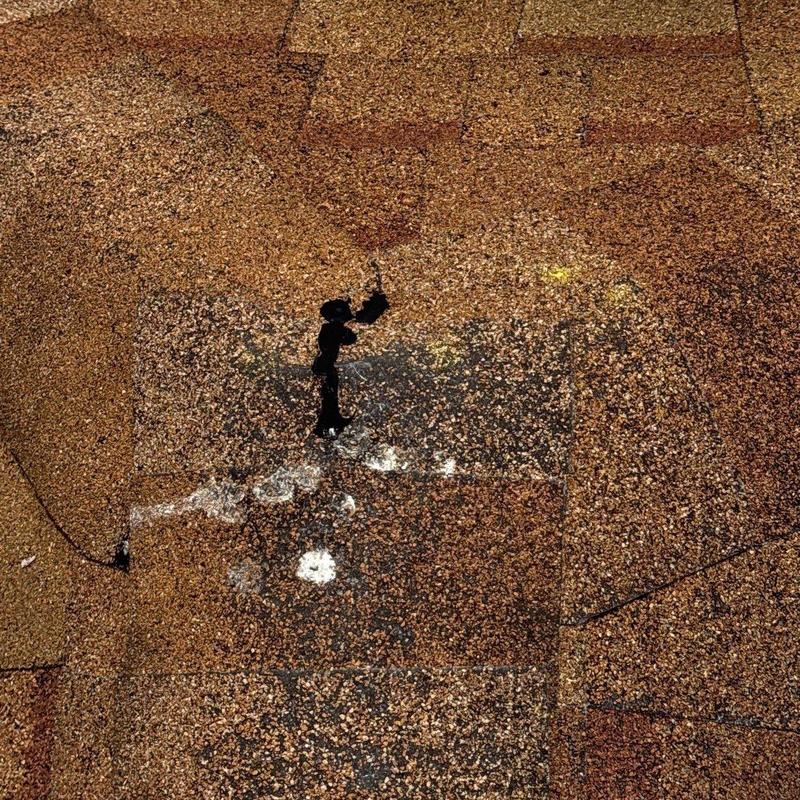 Asphalt shingles with hail damage and repair sealant