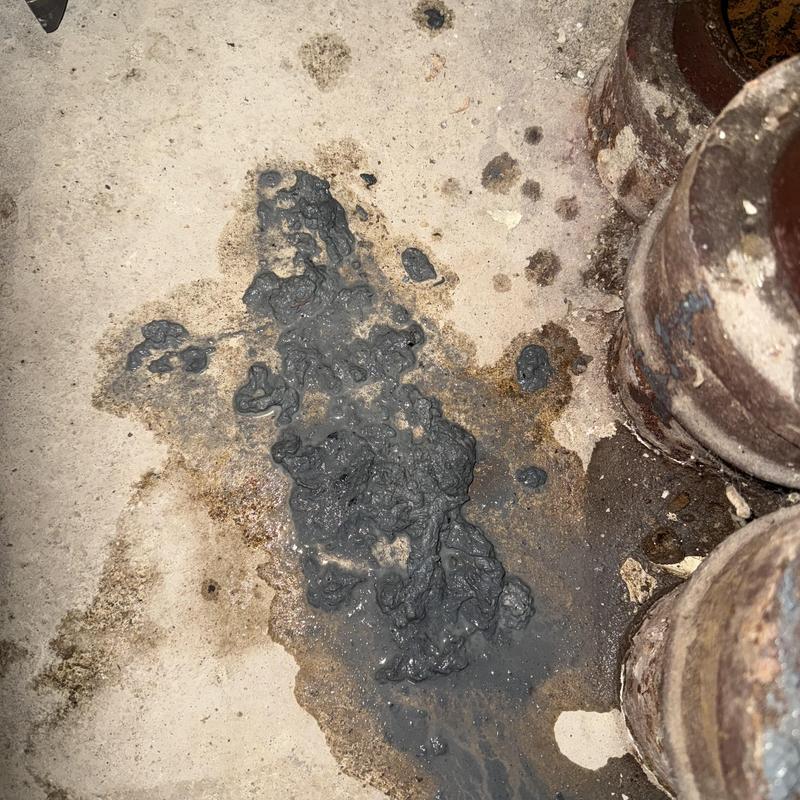 Main line sewer clog with sludge and rusted pipes