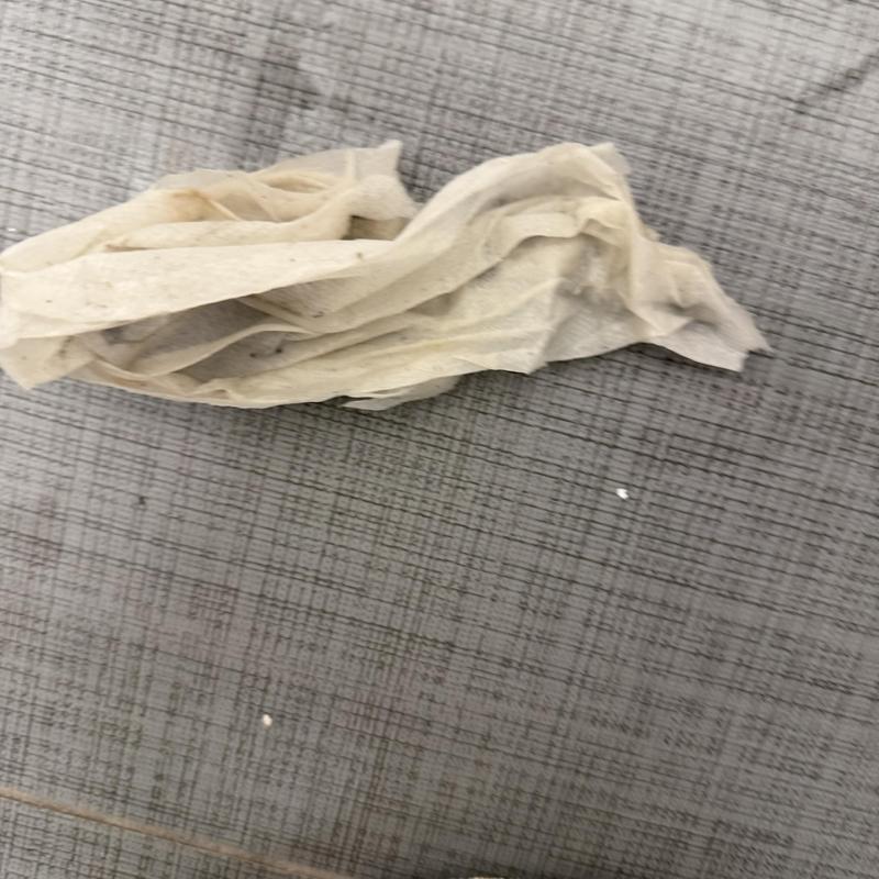 Drain pipe obstruction with tissue debris on floor