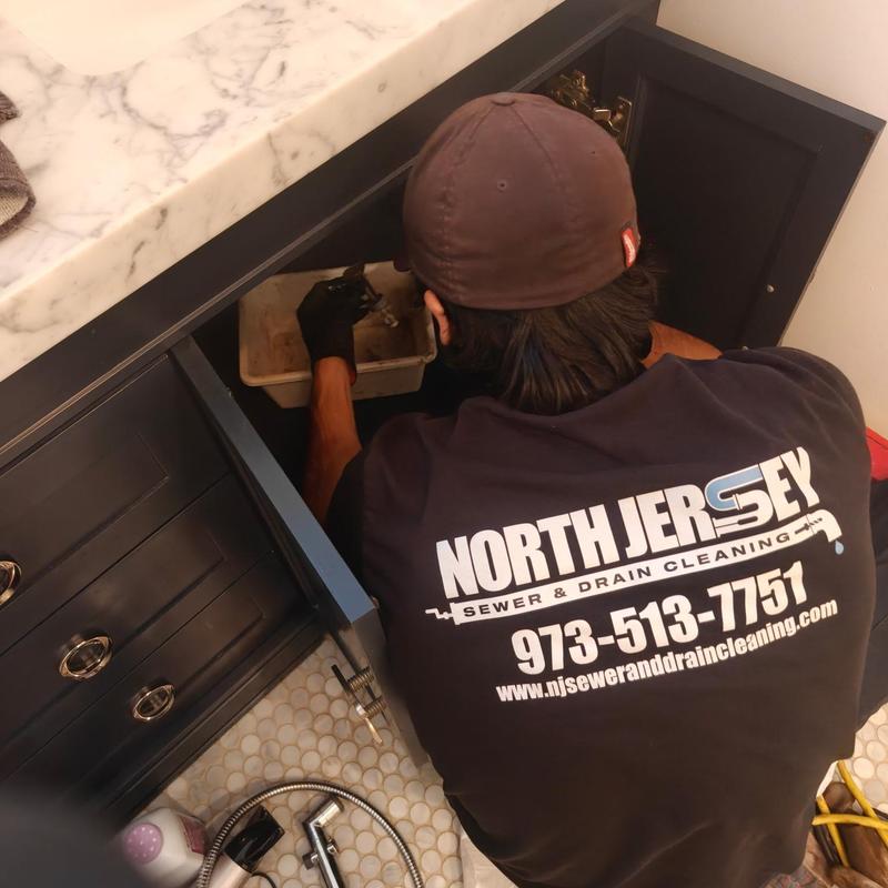 Bathroom secondary plumbing line maintenance under sink cabinet