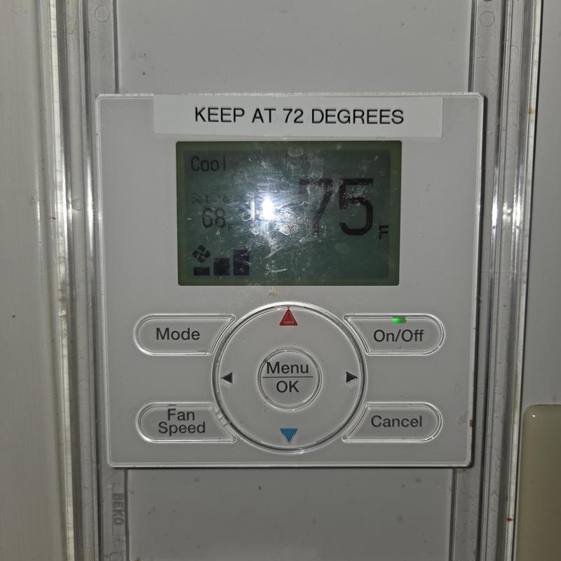Thermostat control panel showing cooling set at 75°F Thermostat control panel showing cooling set at 75°F