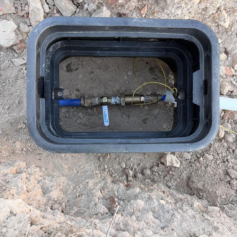 Water service valve box with blue service line installation Water service valve box with blue service line installation