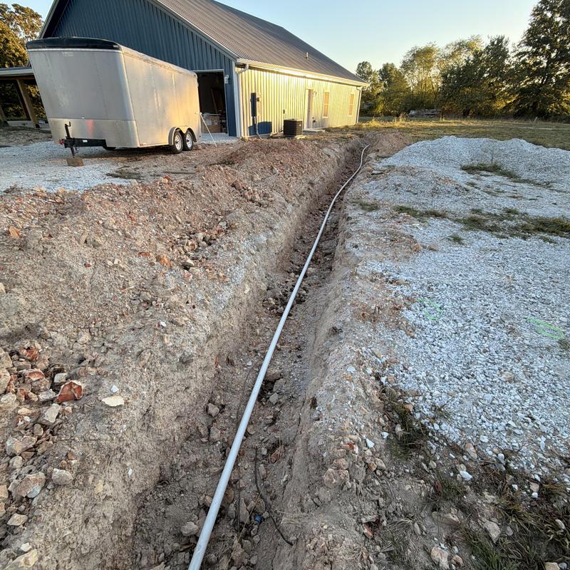 Water service line installation trench near building Water service line installation trench near building