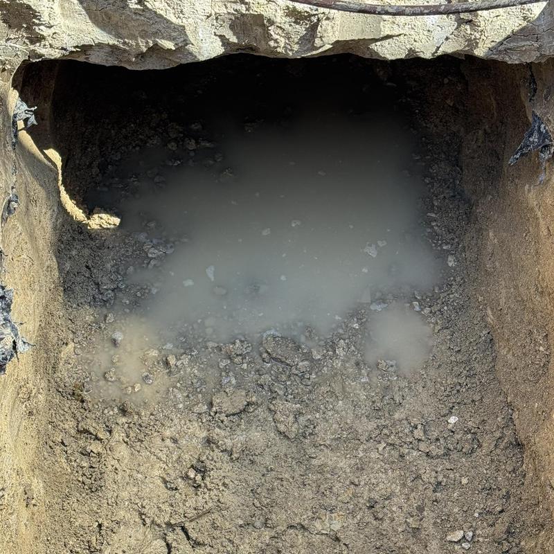 Concrete slab excavation with pooled water inside tunnel