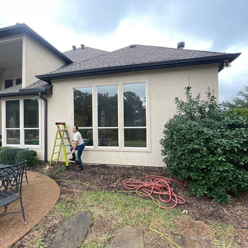 Stucco exterior wall with ladder and garden hose Stucco exterior wall with ladder and garden hose