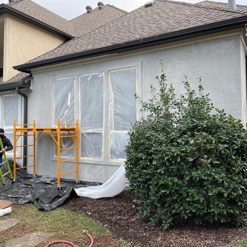 Stucco exterior wall with fresh repair and scaffolding Stucco exterior wall with fresh repair and scaffolding