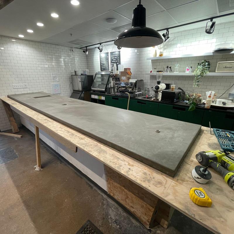 Concrete countertop installation in commercial cafe setting Concrete countertop installation in commercial cafe setting