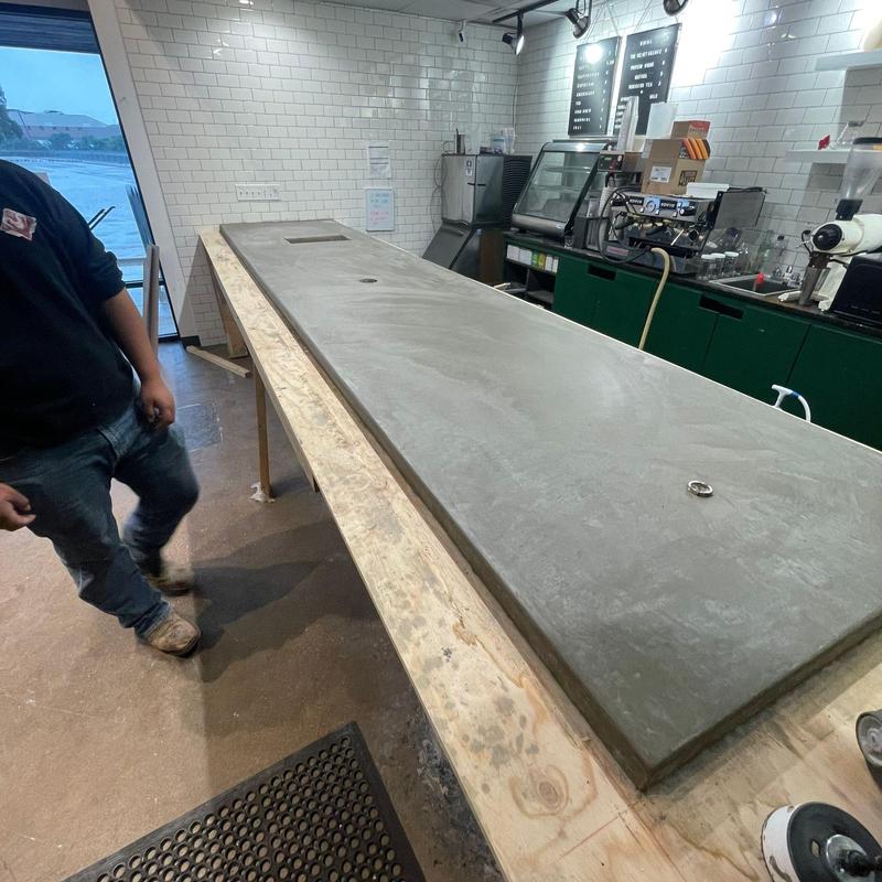 Concrete countertop installation in café setting Concrete countertop installation in café setting