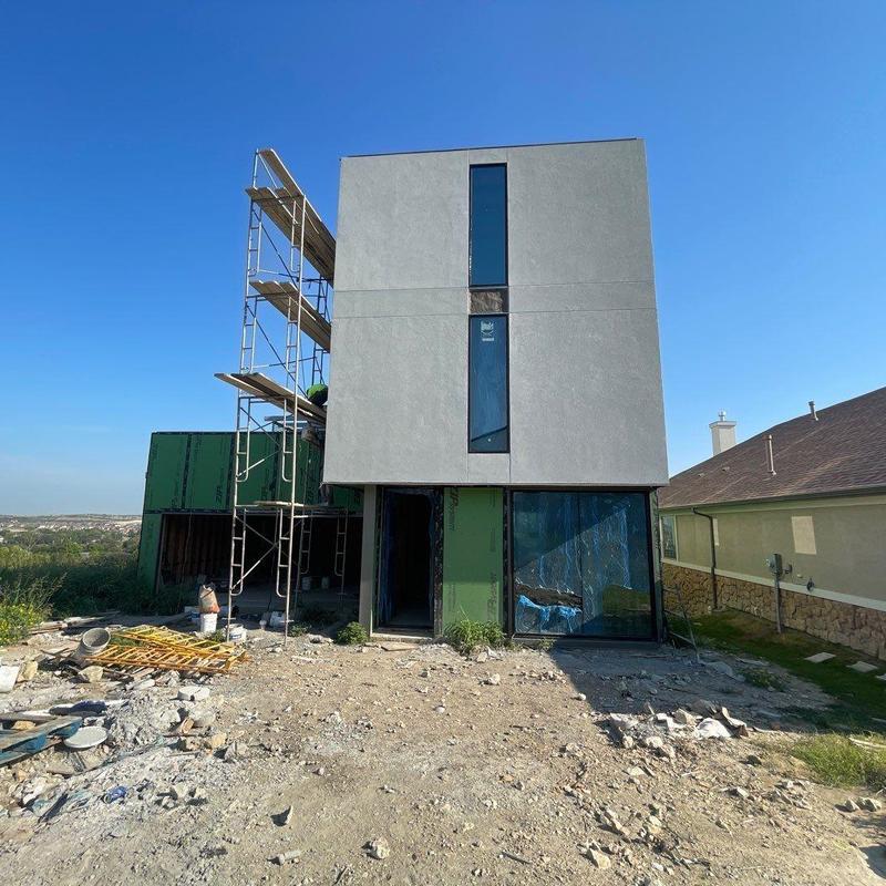 Stucco exterior finish on modern home facade Stucco exterior finish on modern home facade