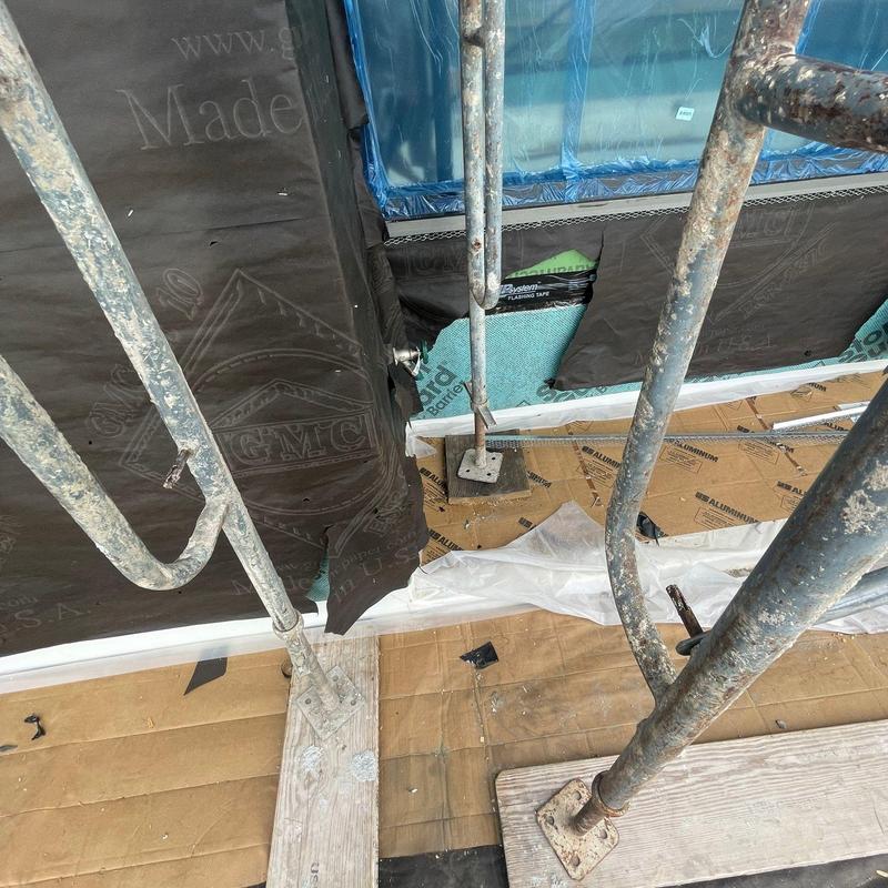 House exterior moisture barrier with scaffolding setup House exterior moisture barrier with scaffolding setup