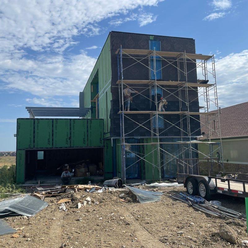 Stucco exterior installation on modern home facade Stucco exterior installation on modern home facade