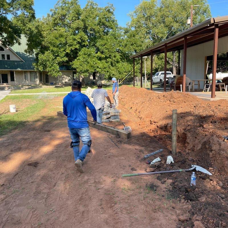 Stone retaining wall foundation preparation at venue Stone retaining wall foundation preparation at venue
