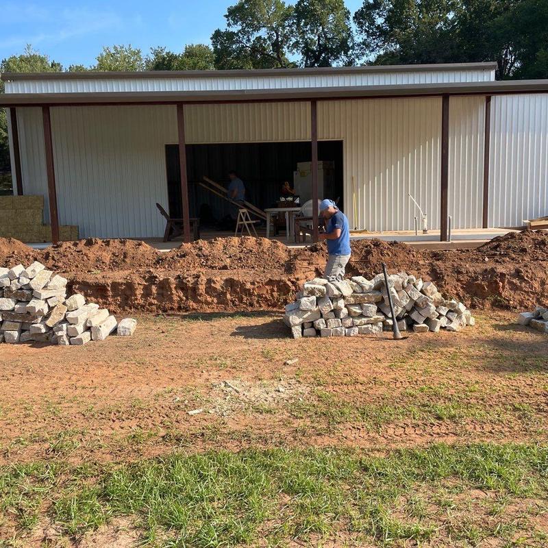 Stone retaining wall foundation and stone prep outdoors Stone retaining wall foundation and stone prep outdoors