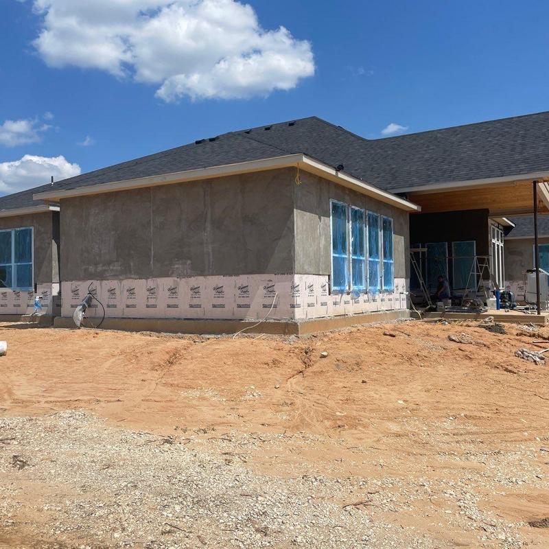 Stucco finish application on new home exterior walls Stucco finish application on new home exterior walls