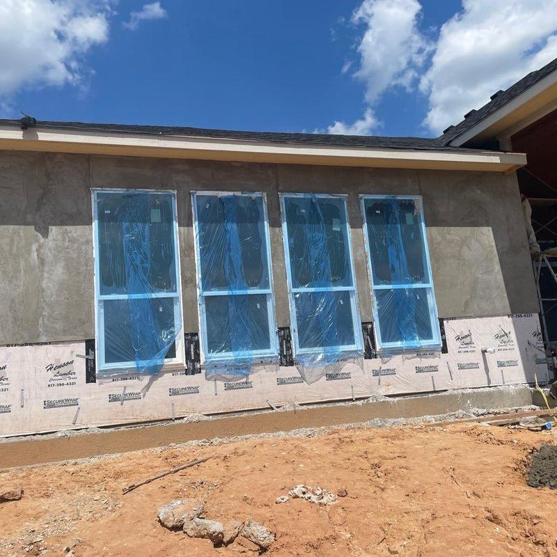 Stucco exterior finish with protected windows installation Stucco exterior finish with protected windows installation