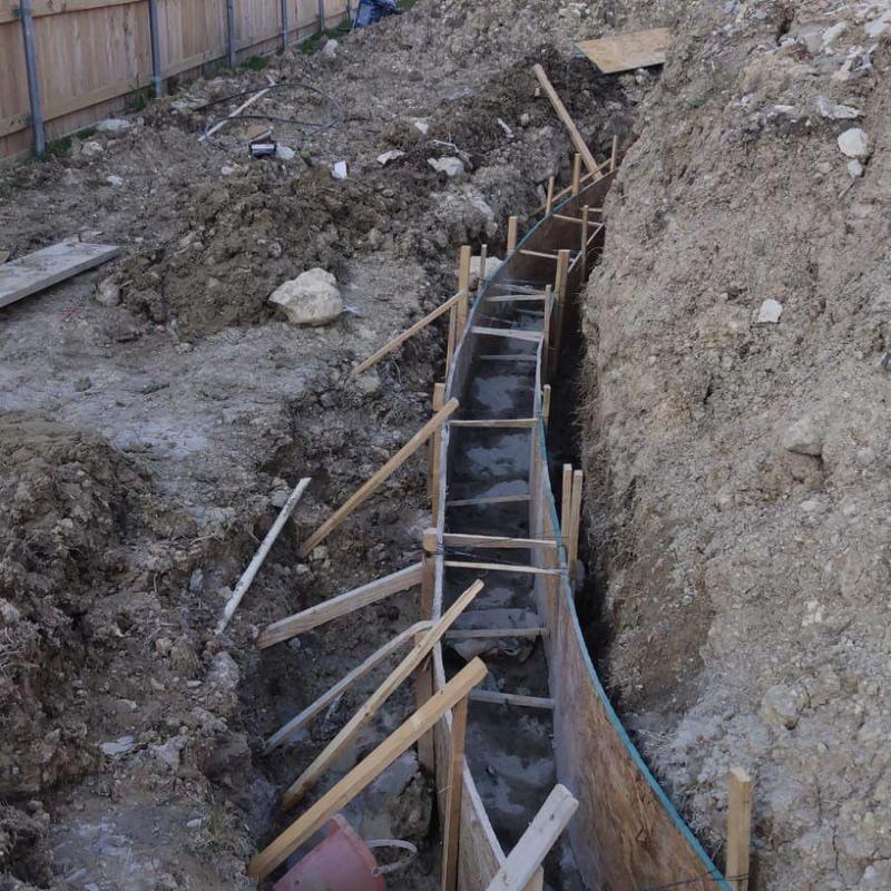 Concrete block retaining wall footing forming beside pool Concrete block retaining wall footing forming beside pool