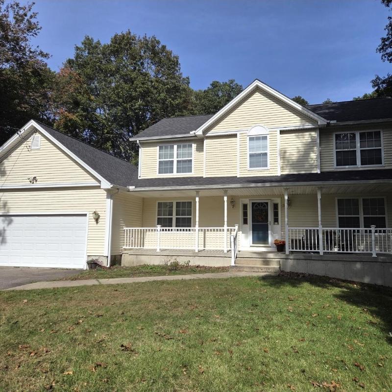 CertainTeed Landmark Pro roof on beige two-story house