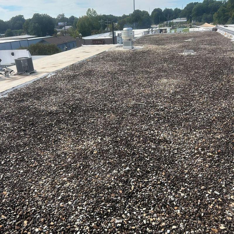 Gravel-surfaced low-slope roof on commercial building Gravel-surfaced low-slope roof on commercial building