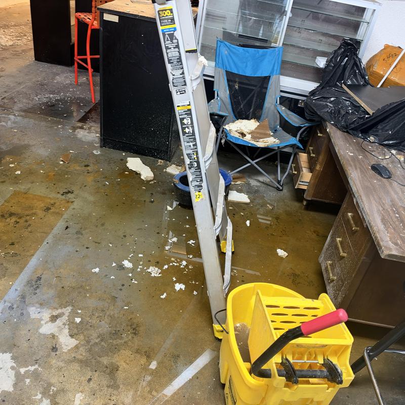 Secondary drain pan with water and debris in office Secondary drain pan with water and debris in office