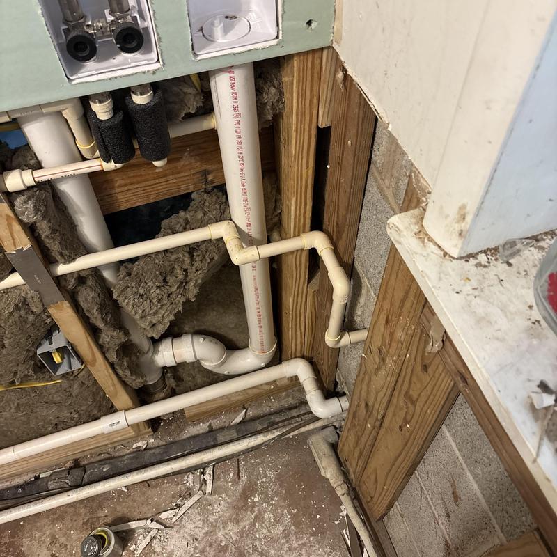 PVC drain pipes installation under floor joists PVC drain pipes installation under floor joists