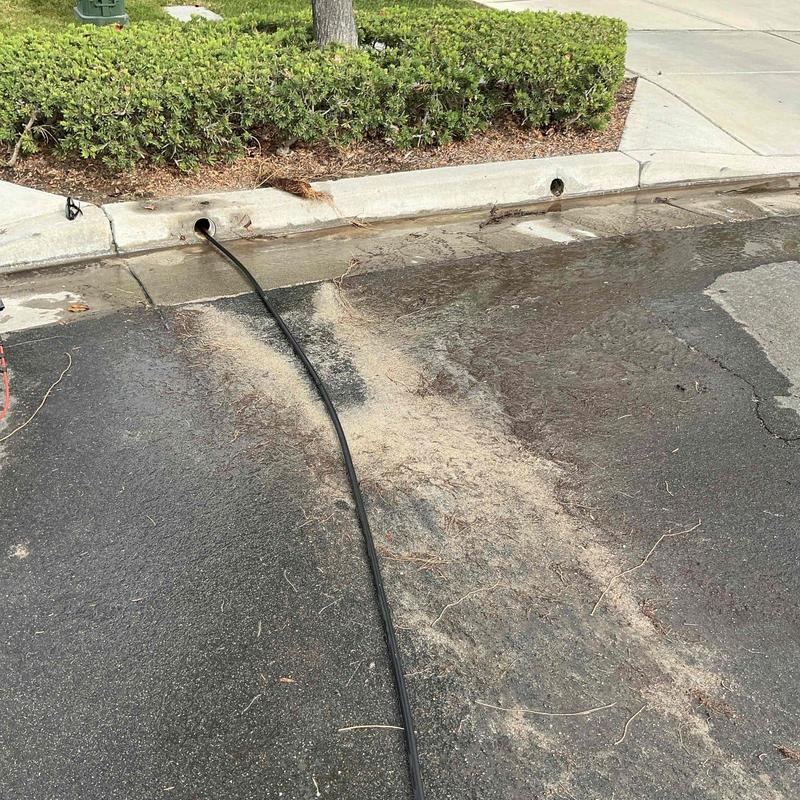 Area drain with hydro-jetting hose inserted