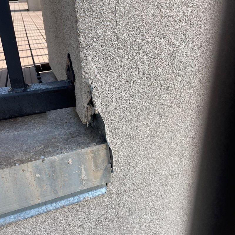 Stucco damage near balcony railing and ledge Stucco damage near balcony railing and ledge