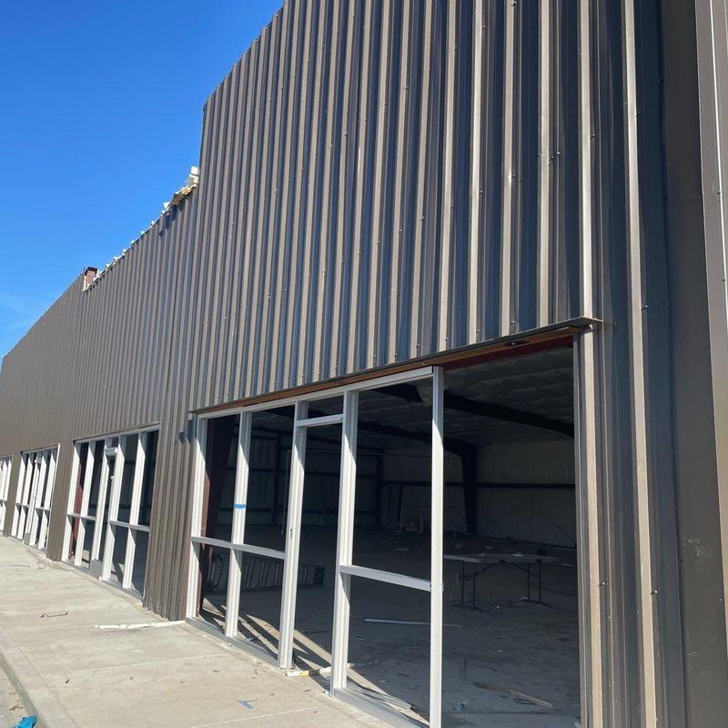 Concrete walkways and curb alongside commercial building Concrete walkways and curb alongside commercial building