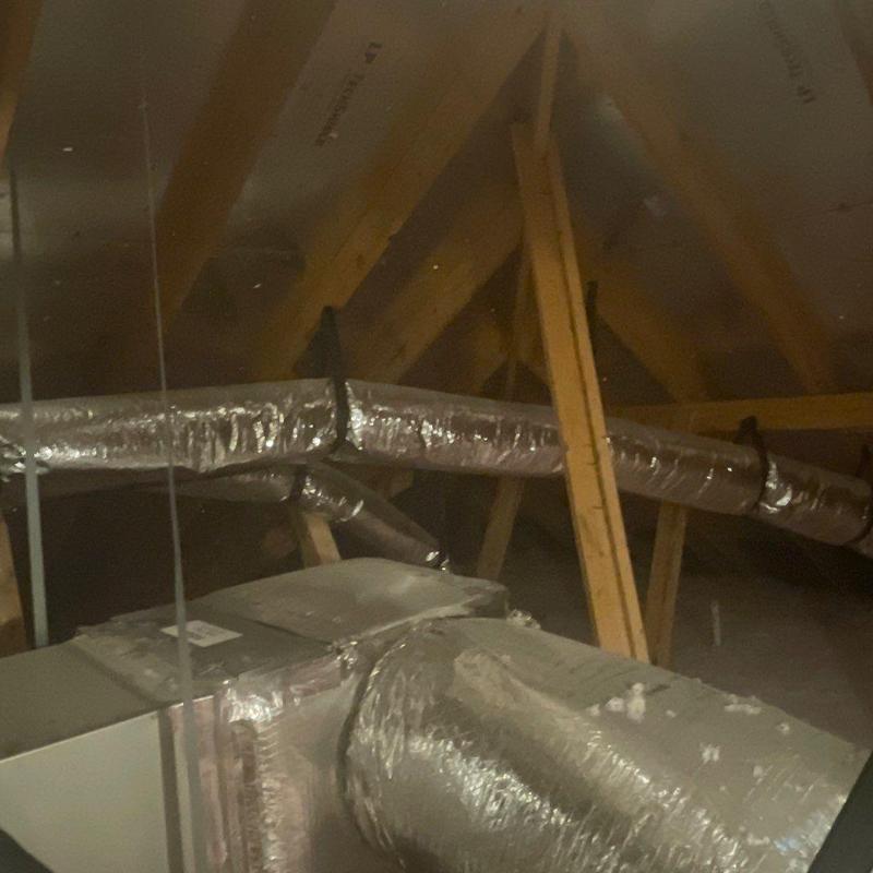 Attic HVAC ductwork with wooden framing in attic space Attic HVAC ductwork with wooden framing in attic space