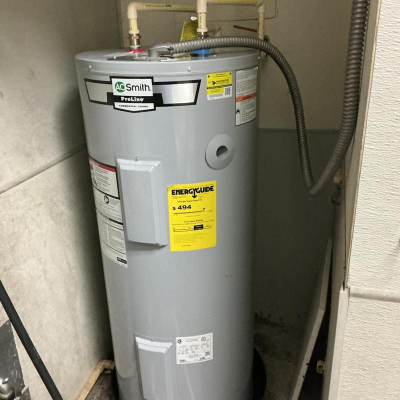 Electric water heater installed in utility closet Electric water heater installed in utility closet