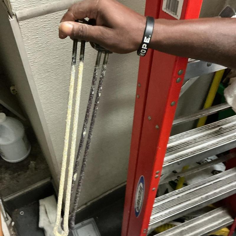 Electric water heater heating elements removed for replacement Electric water heater heating elements removed for replacement
