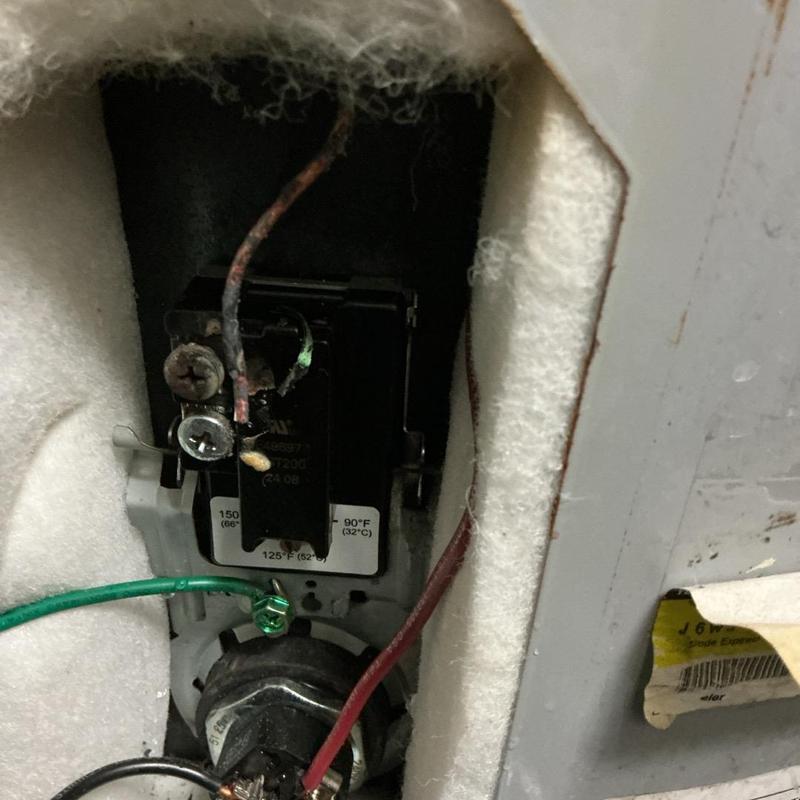 Electric water heater thermostat with burnt wiring damage Electric water heater thermostat with burnt wiring damage