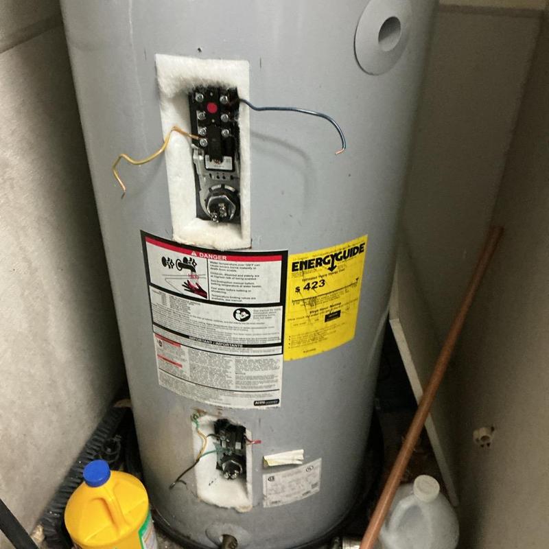 Electric water heater thermostat and wiring exposed Electric water heater thermostat and wiring exposed