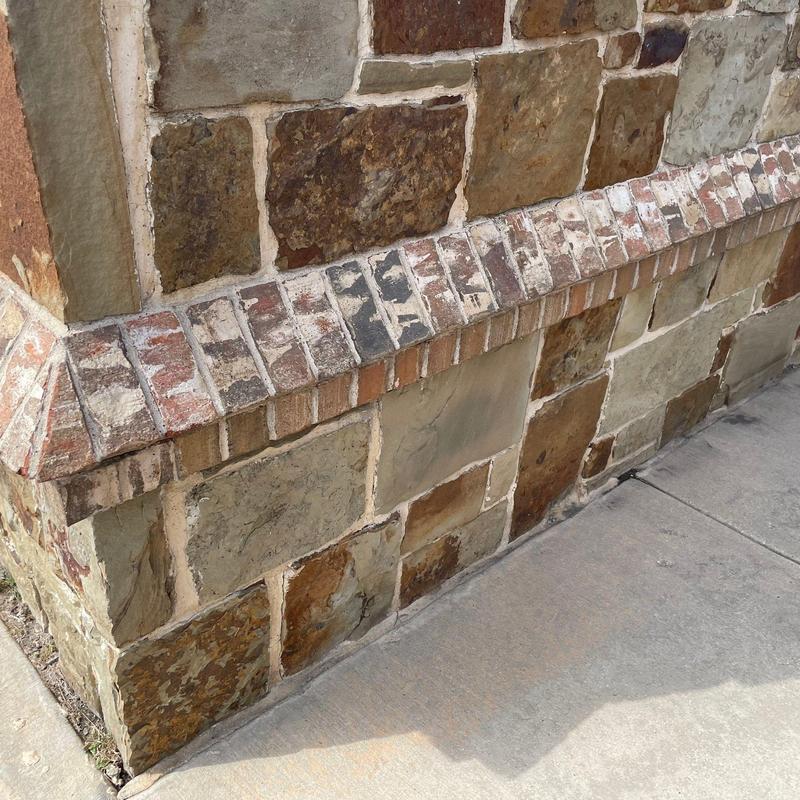 Stone-and-brick wall masonry restoration at business entrance Stone-and-brick wall masonry restoration at business entrance