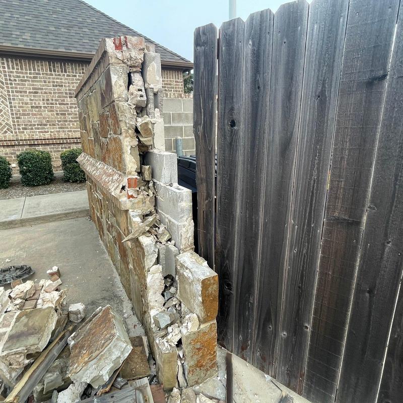 Stone and brick wall damaged section with rubble Stone and brick wall damaged section with rubble