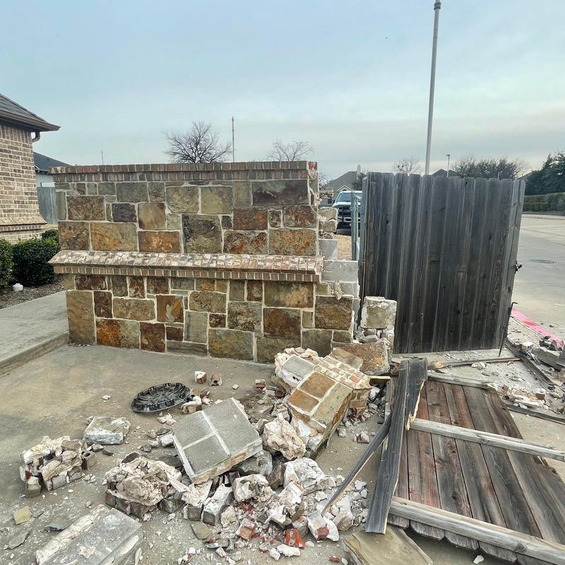 Stone and brick wall damage with broken wooden gate Stone and brick wall damage with broken wooden gate