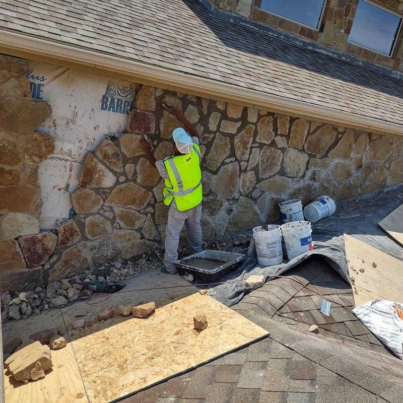 Exterior stone veneer matching and setting beneath roofline Exterior stone veneer matching and setting beneath roofline