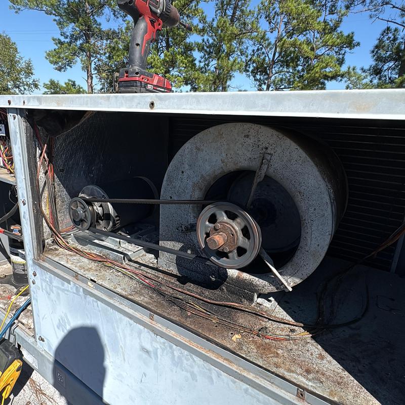 Commercial AC blower wheel and belt inspection outdoors Commercial AC blower wheel and belt inspection outdoors