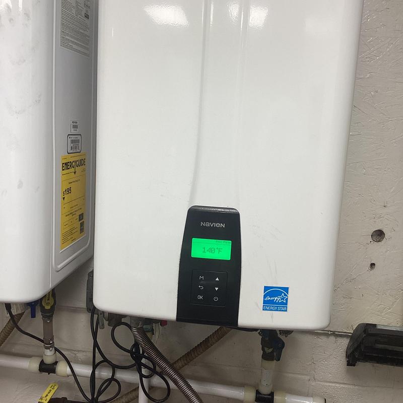 Tankless water heater control panel displaying 140°F Tankless water heater control panel displaying 140°F