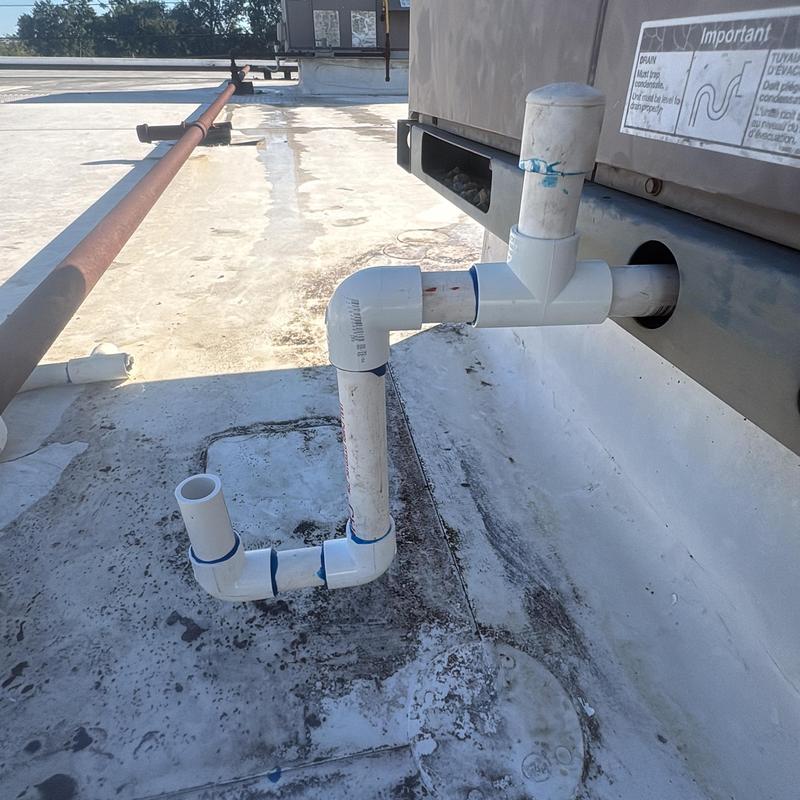 Commercial AC condensate drain PVC piping on rooftop Commercial AC condensate drain PVC piping on rooftop